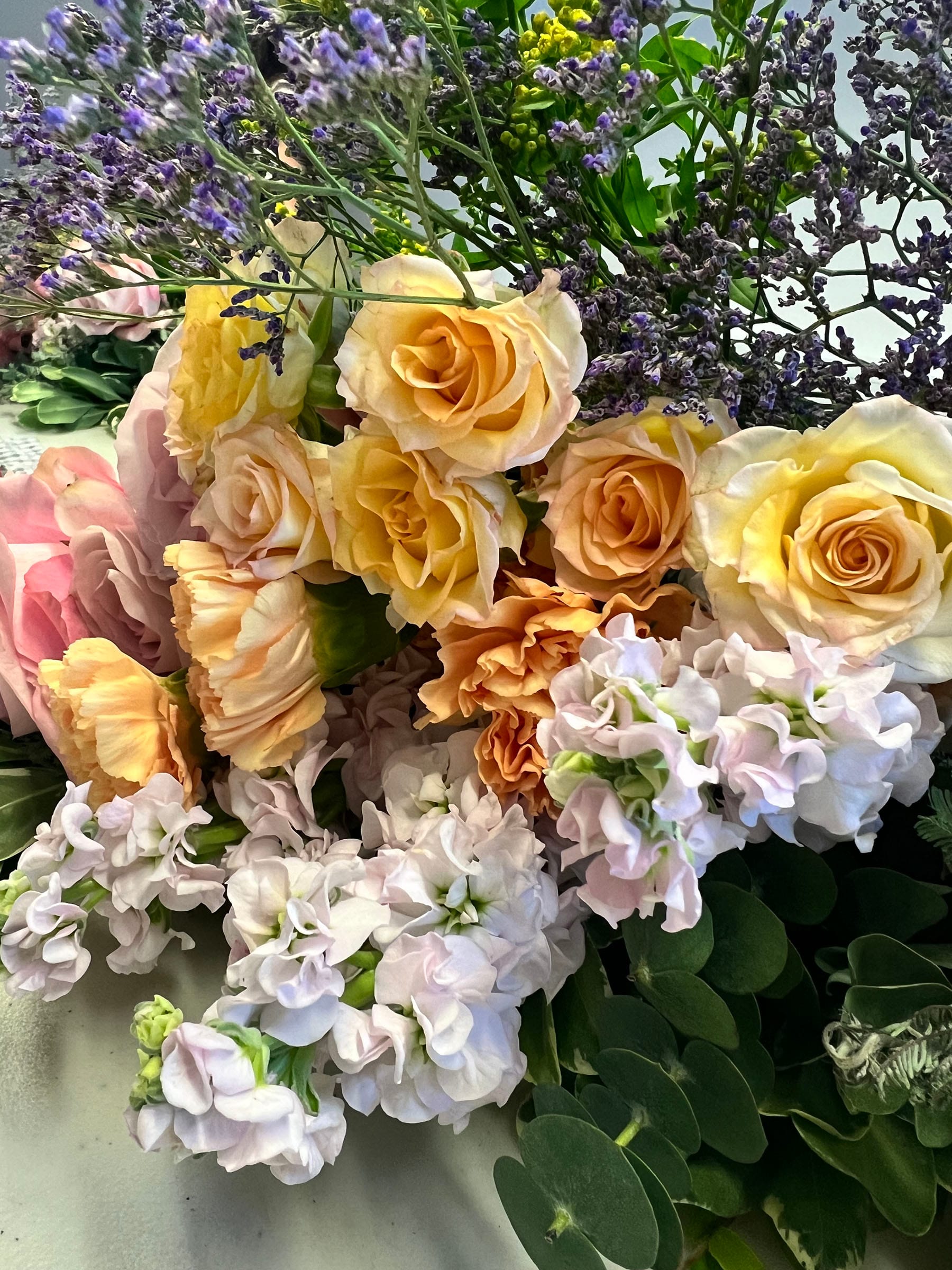 Colourful bouquet with roses and greenery.