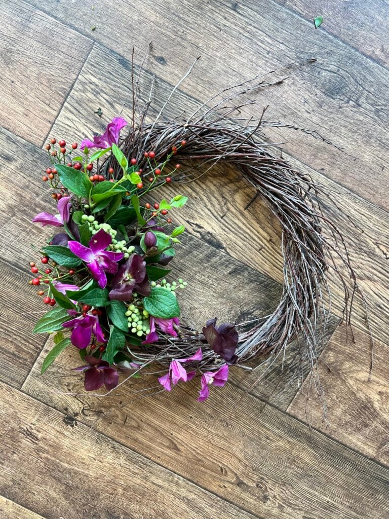 Natural twig funeral wreath with orchids, berries and rosehips