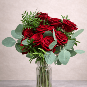 Bouquet of red roses and greenery in vase