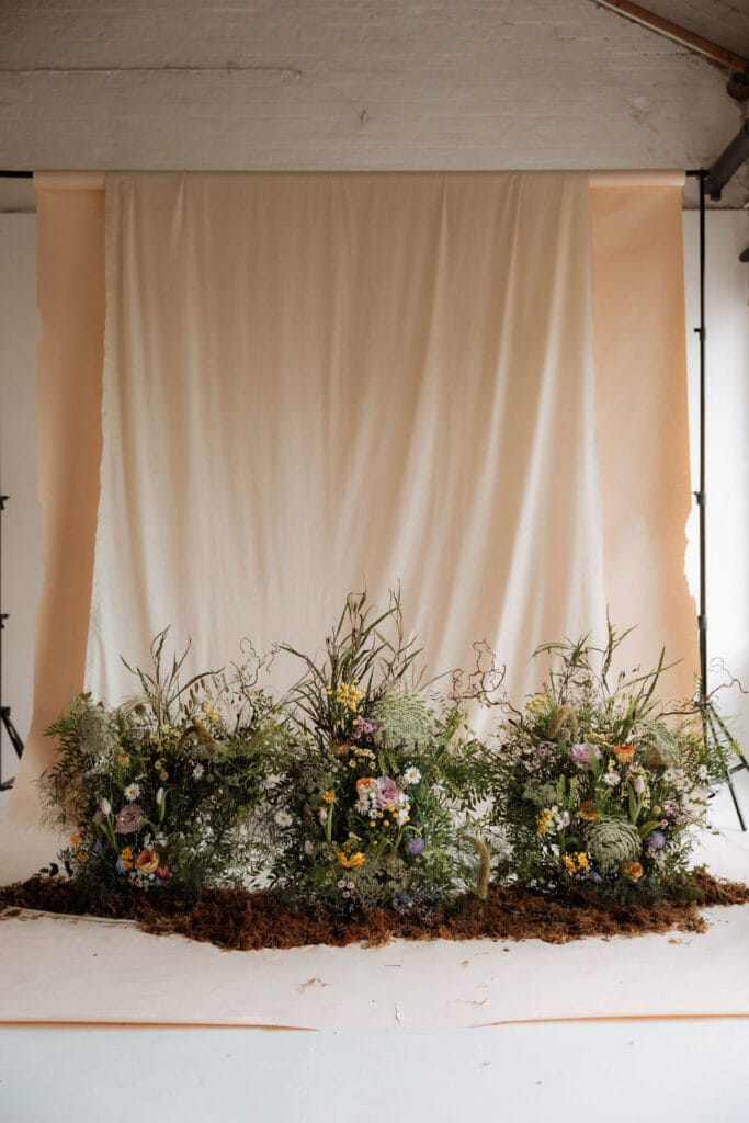 Backdrop with lush floral arrangement.