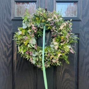 Floral wreath on dark wooden door