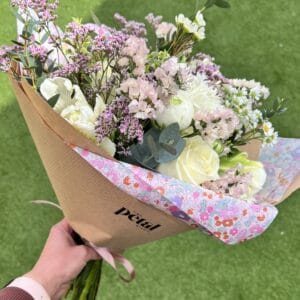 Pastel bouquet of roses and wildflowers outdoors