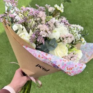 Pastel bouquet of roses and wildflowers outdoors